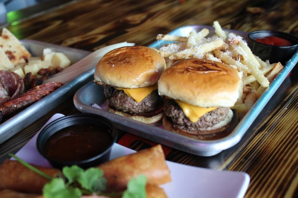 A photo of sliders with fries 