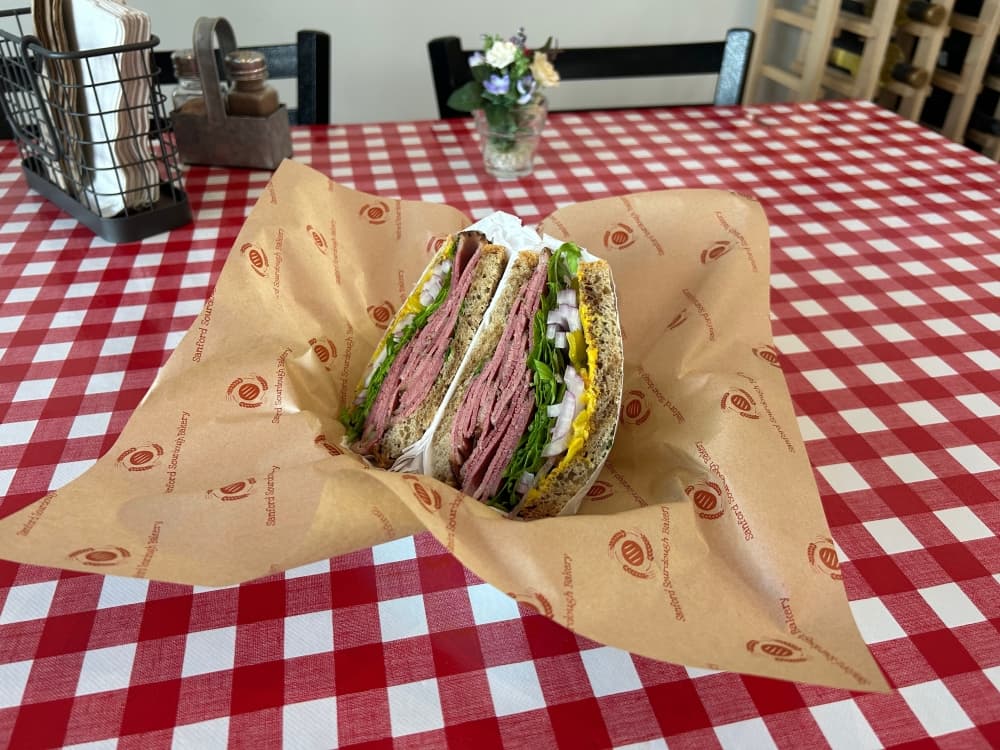 One of the more popular sandwiches on the bakery's menu is the pastrami on marbled rye ($14.45) made with pastrami sourced from San Marcos. (Brooke Sjoberg/Community Impact)