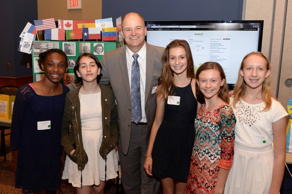 Henry poses with students at the Horizons Student Showcase in 2016. (Courtesy Cy-Fair ISD)