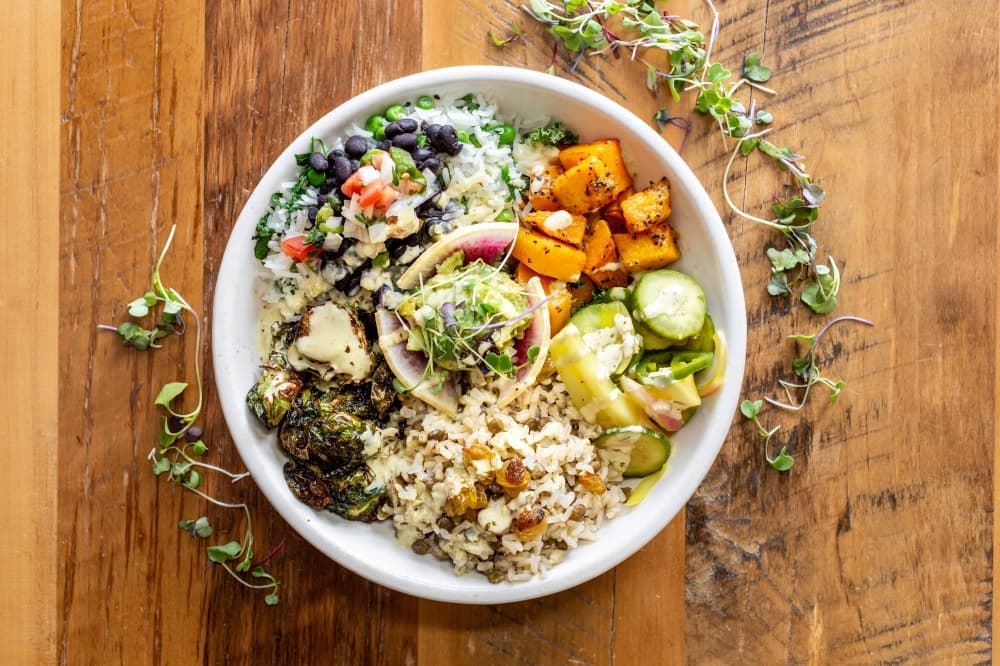 A bowl of mixed vegetables and grains.