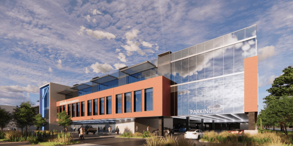 This is a rendering of the three-story medical office building with an attached two-story parking garage and an additional subsurface parking level.