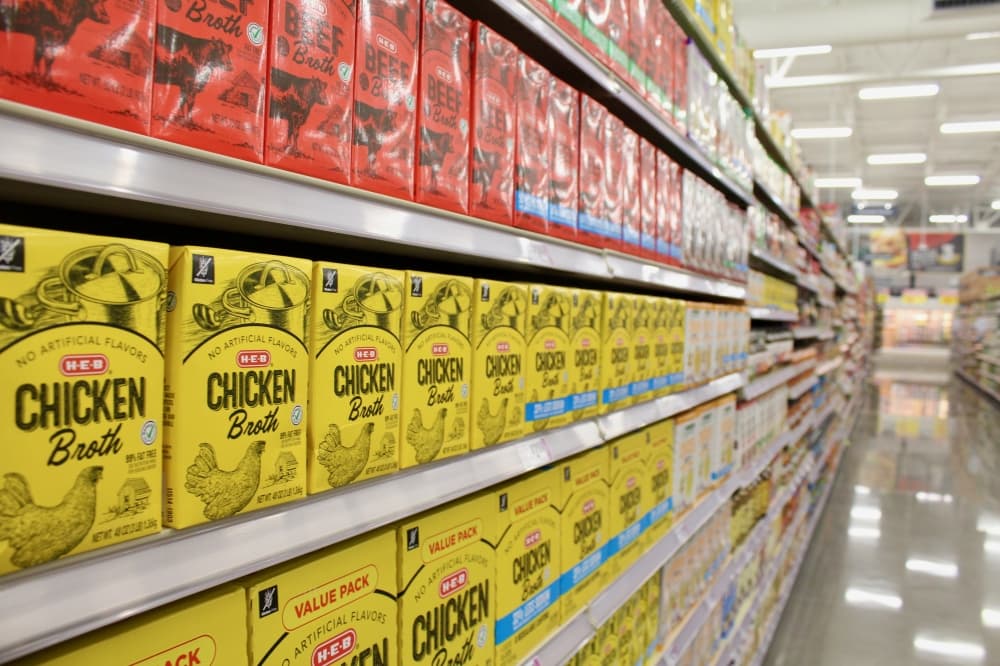 Shelves stocked with chicken broth