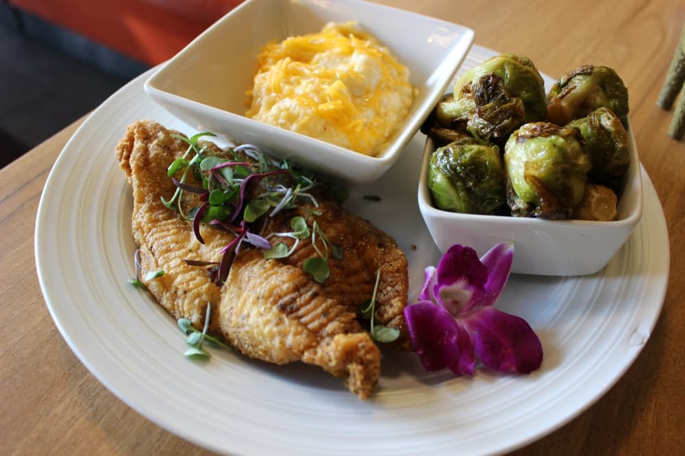 Catfish ($25) is served fried, blackened or jerk style. It is pictured served with mashed potatoes and brussels sprouts.