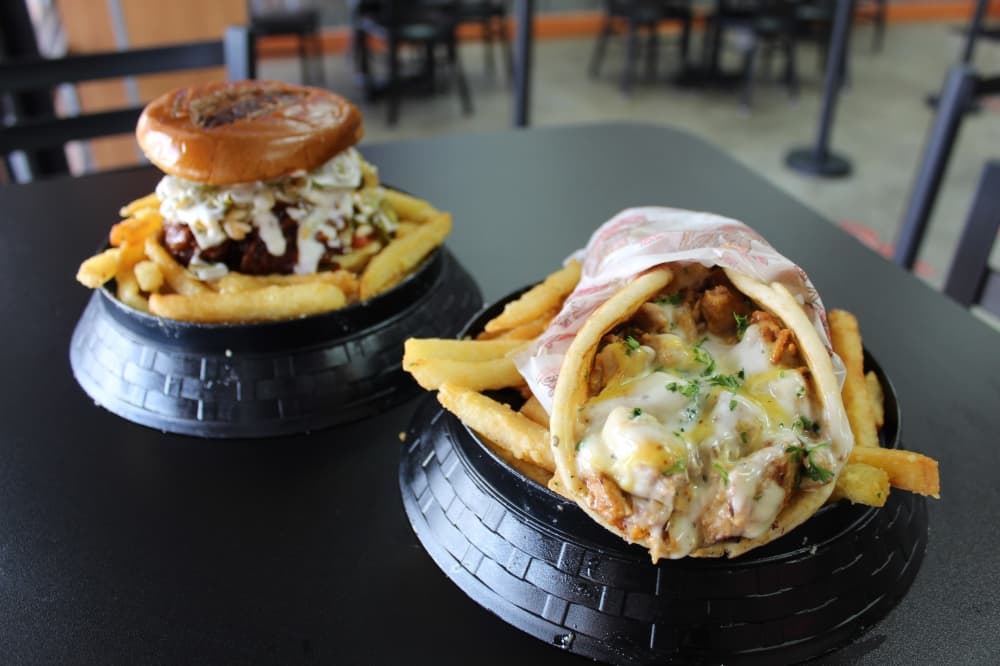 two gripper meal plates with sandwiches and fries