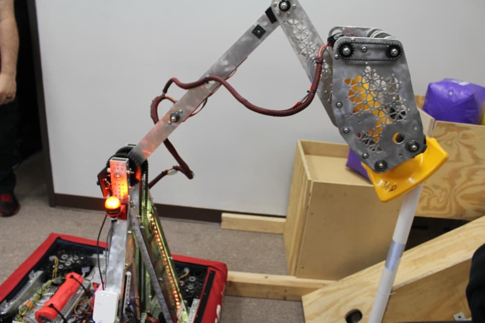Robot built by students putting a cone on a stick
