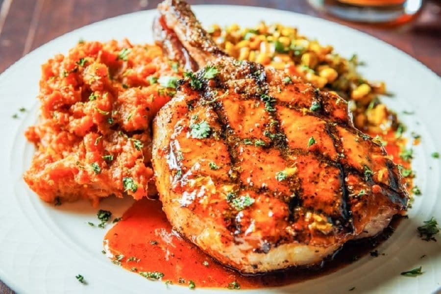 The chipotle pork chop ($26.50) comes with a honey glaze, cilantro, chipotle sweet potatoes and vegetable of the day. (Courtesy Verde's Mexican Parrilla)
