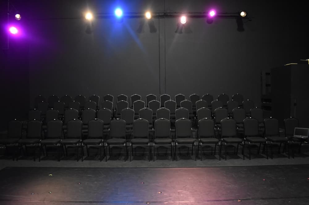An empty audience at a black box theater