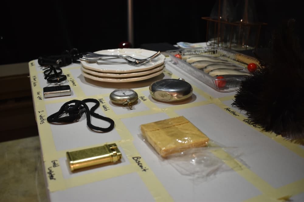Props for a play sitting on a labeled table
