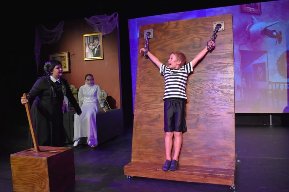 Three student actors performing 
