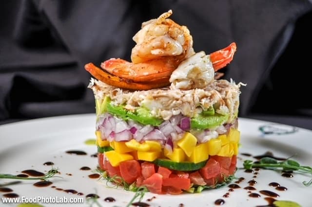 Lump Crab and Shrimp Tower - This tower is served in layers of avocado, mango, french cucumber, red onion, tomato toped with lump crab meat, seasoned shrimp, unagi and cilantro lime sauce, served with friend wonton chips. (Courtesy Marais)