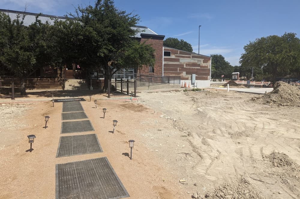 Parking lot and patio space under renovation at Katy Trail Ice House Outpost