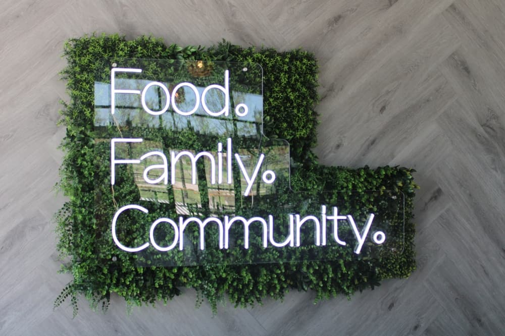 Sign that reads “food, family and community.”
