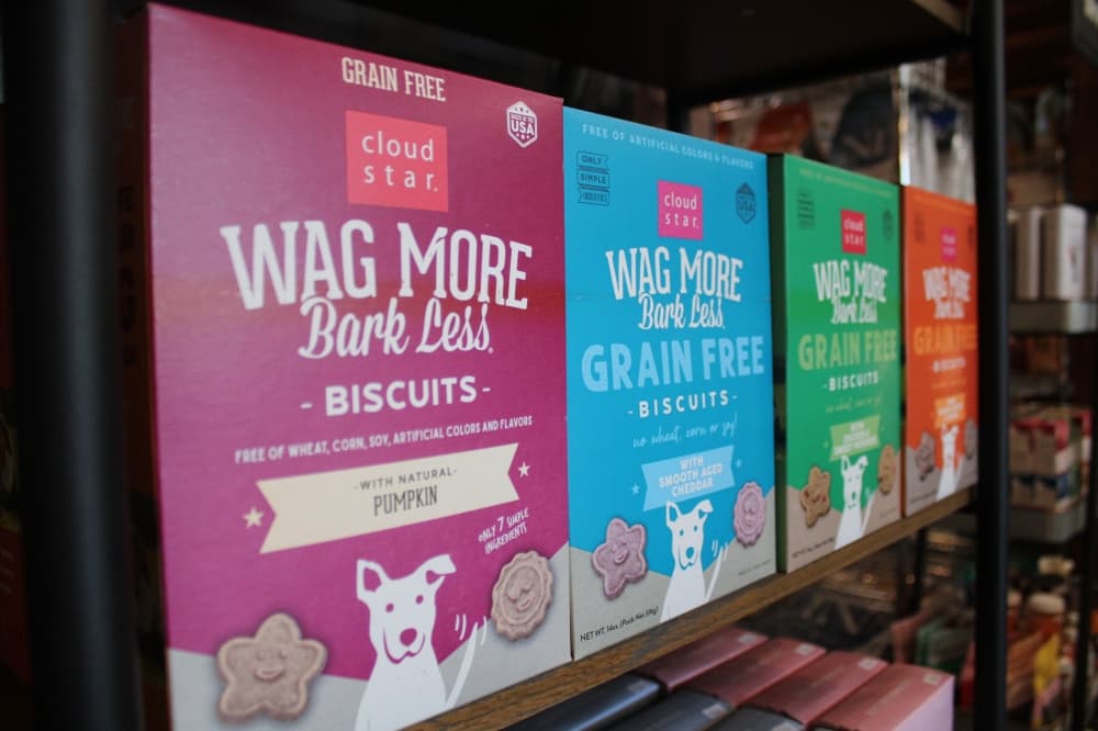 Dog treats lined up on a shelf.