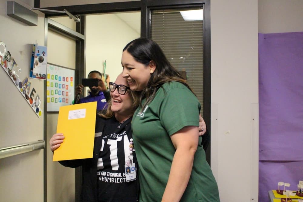 From left, Melinna Lopez, Humble ISD Education Foundation resource development coordinator, presents Amy Walker, Humble High School health science teacher, with an $8,650 grant through the nonprofit's innovative educator grant program. (Courtesy Humble ISD Education Foundation)