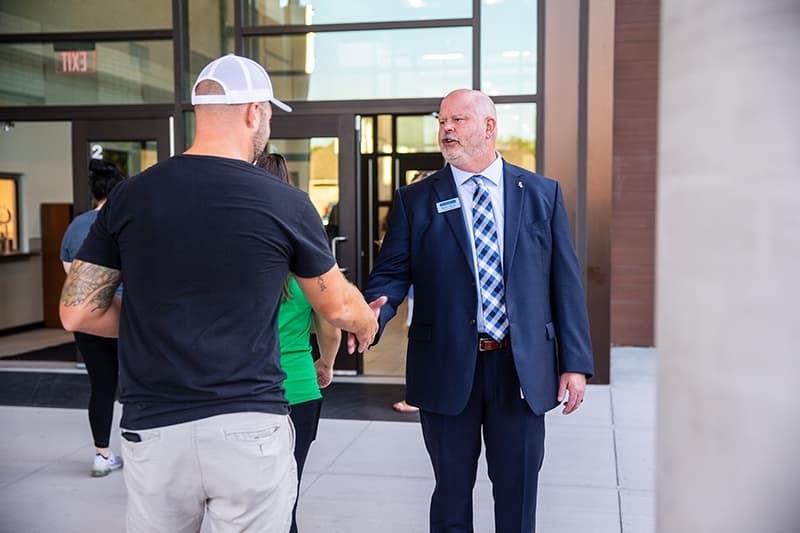 Shawn Pratt shaking a man's hand