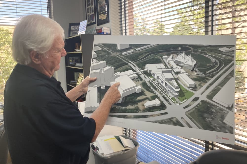 Jerry MacDonald points to a rendering 