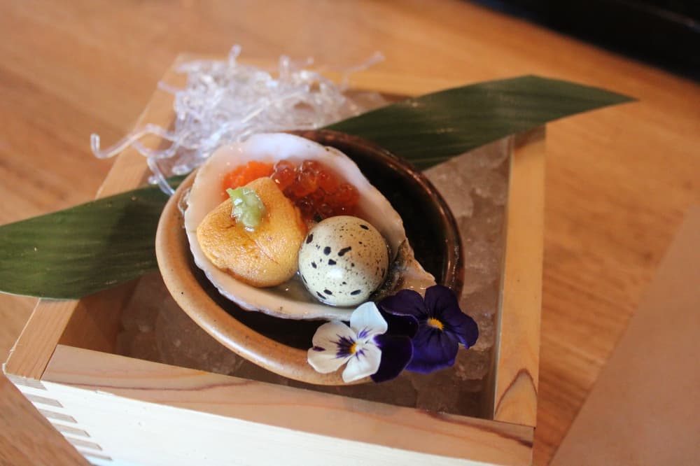 Oyster with quail egg.