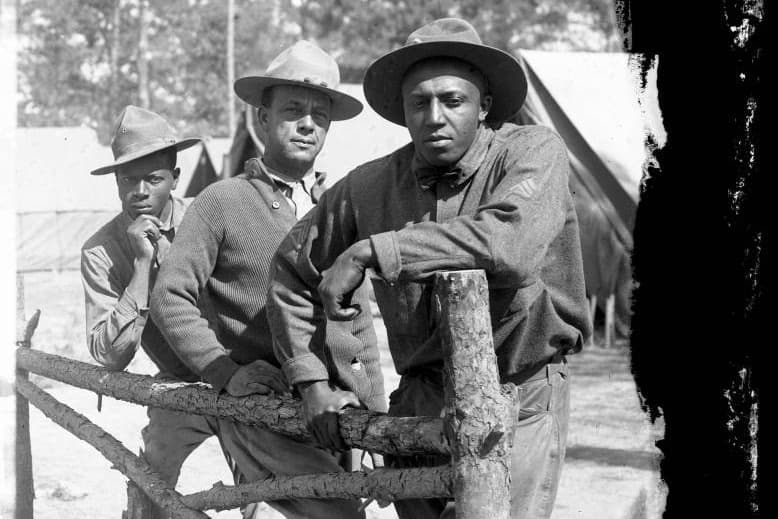 Three African American soldiers post against a fence at Camp Logan. (Courtesy Fred Vermillion, Camp Logan Collection, Houston Metropolitan Research Center, Houston Public Library)