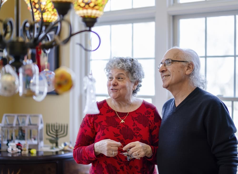The senior couple decorating their house for winter holidays
