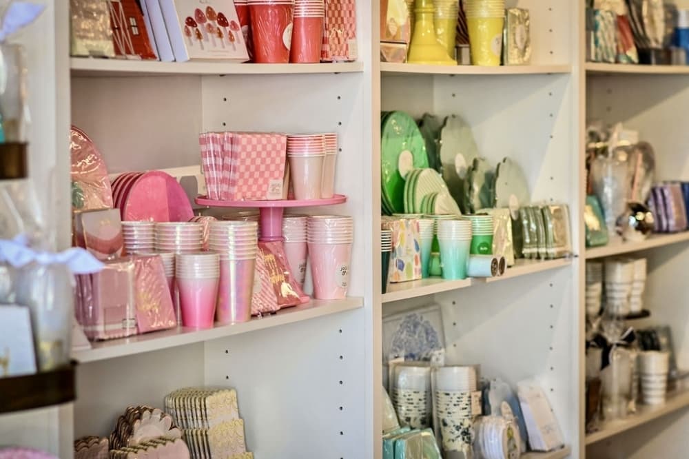 Products offered at Jen Loves Paper including cups, napkins, koozies and stationery