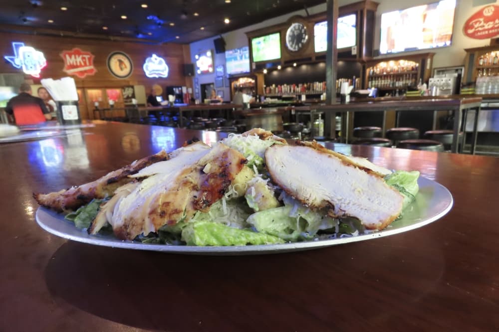 Serving of chicken caesar salad at Katy Trail Icehouse