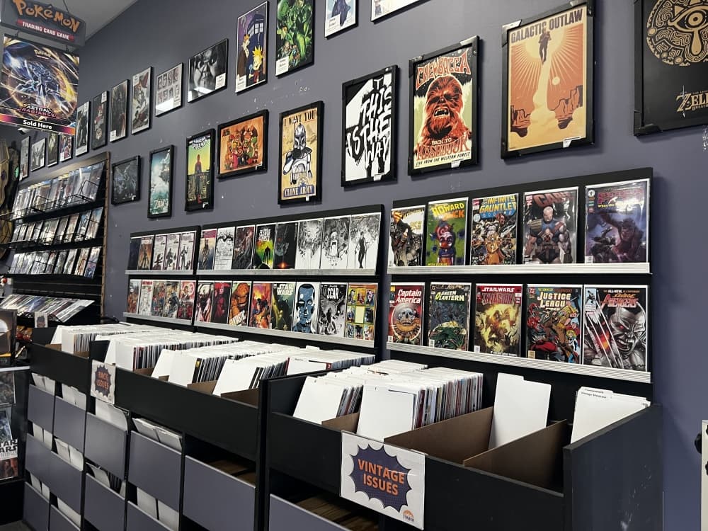 section with vintage comics on the wall and in boxes 