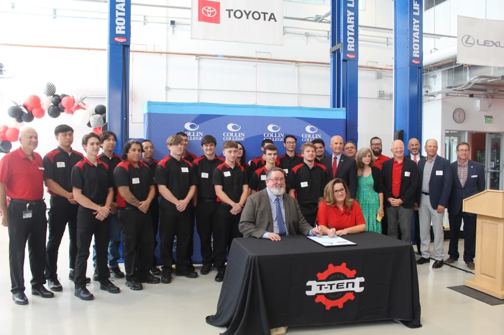 Collin College District President Neil Matkin and Holly Dieterle, Toyota general manager of quality division, pose with the T-TEN program's first cohort. (Michael Crouchley/Community Impact)