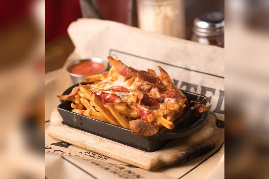 Dough Bro's Italian Kitchen and Bar added three new starters and three new signature pizzas to its menu Aug. 28. Pizza fries are made up of house fries topped with mozzarella cheese, marinara sauce and choice of chicken, meatball, beef, pepperoni or sausage. (Courtesy Dough Bro's Italian Kitchen and Bar)