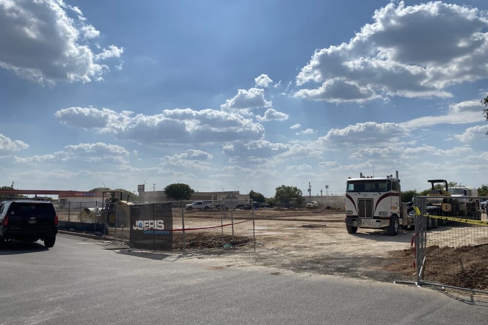 Trucks prepare lot for expanded parking lot.