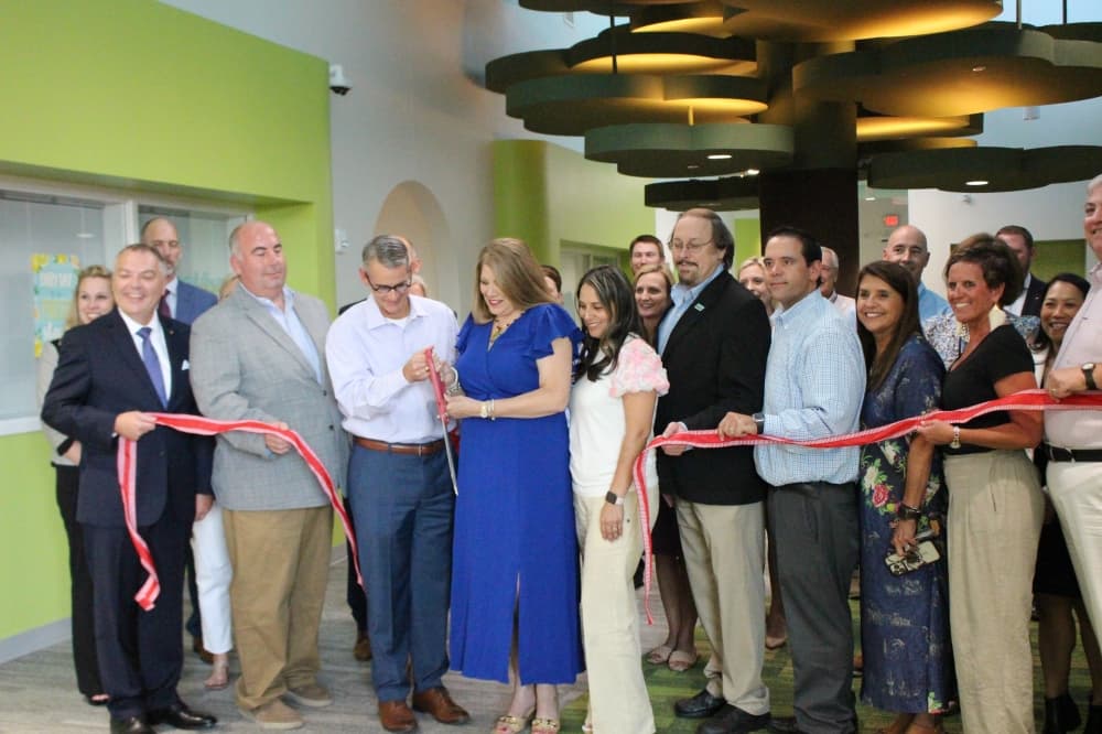 The photo shows Tomball ISD staff and trustees cutting a ribbon.