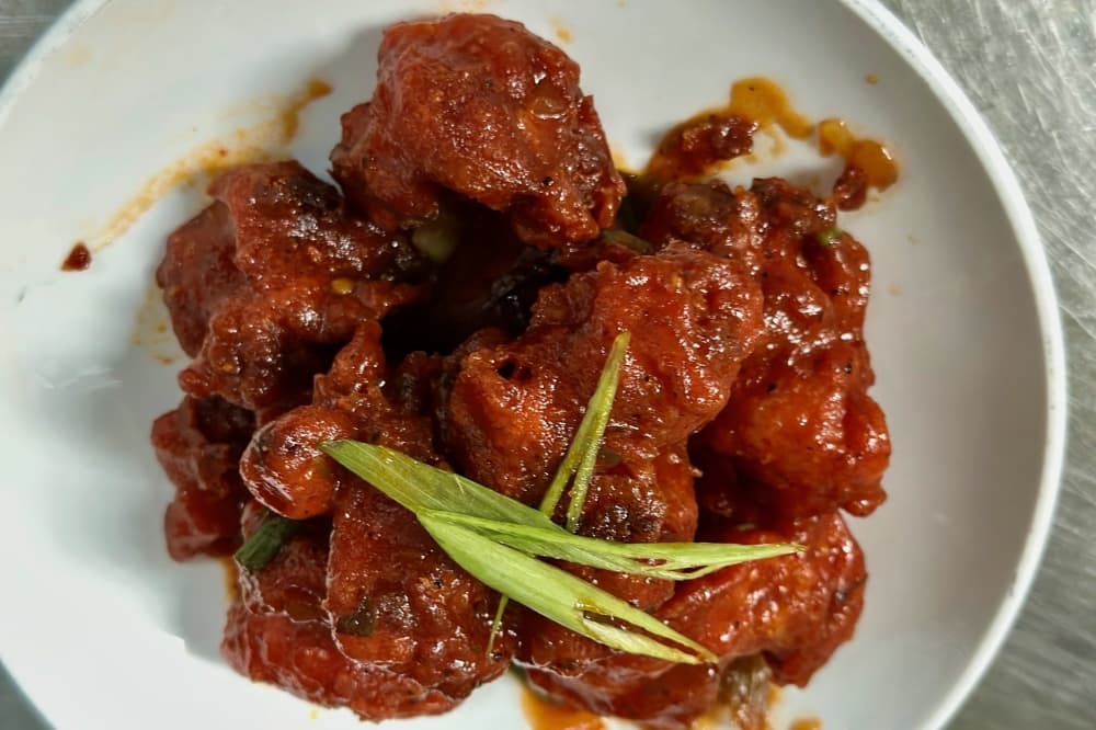 Fried golden cauliflower flowerets folded in a tangy Tomato and garlic sauce finished with soy. 