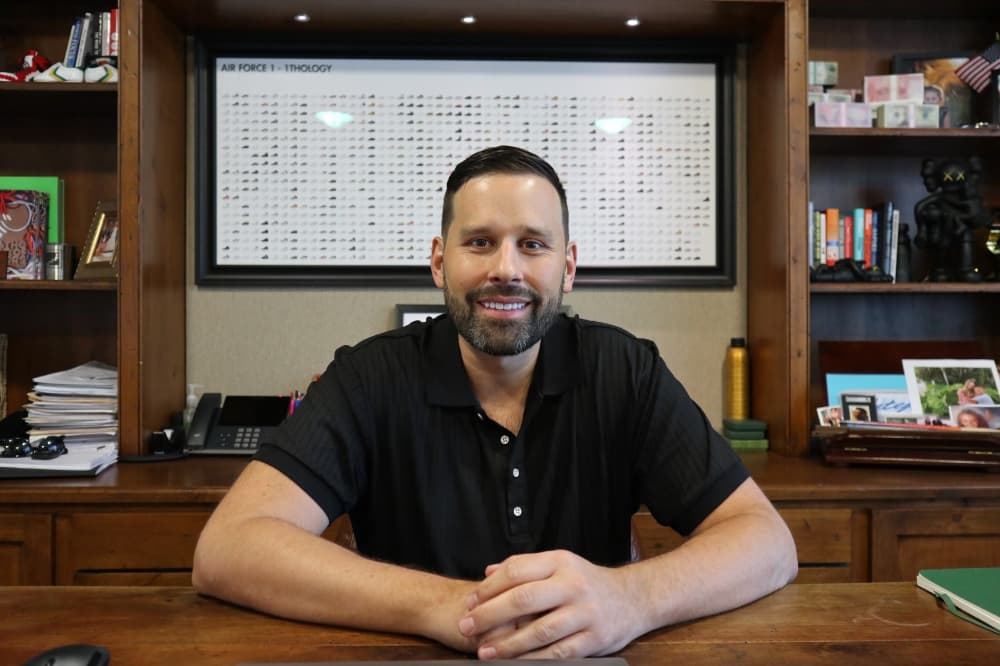 New owner Mitch Johnson sits at his desk 