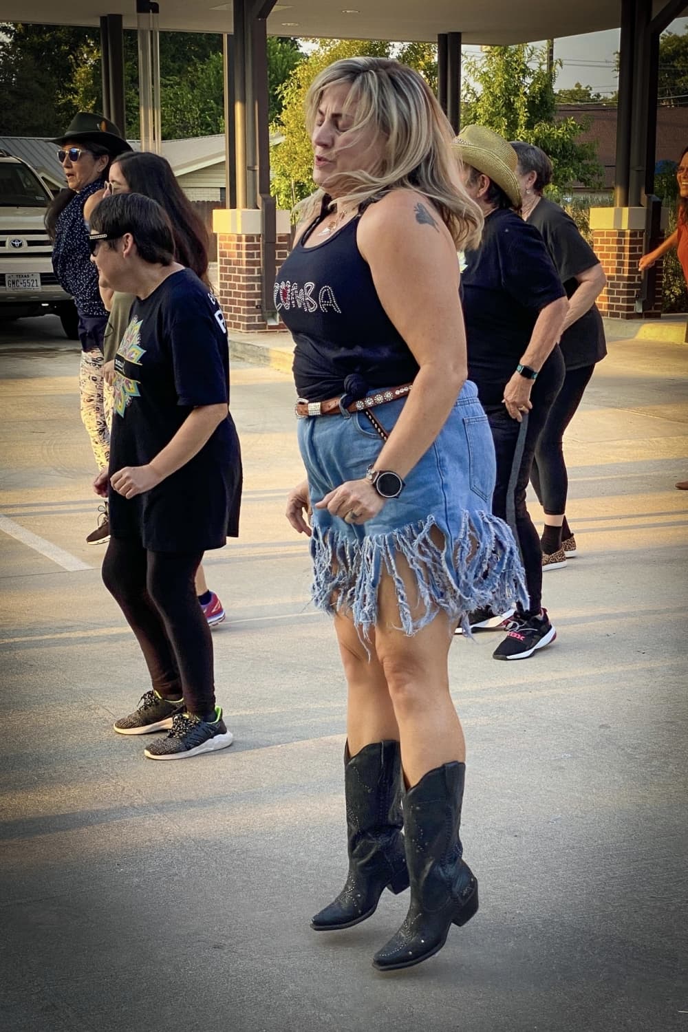 A group dances outside.