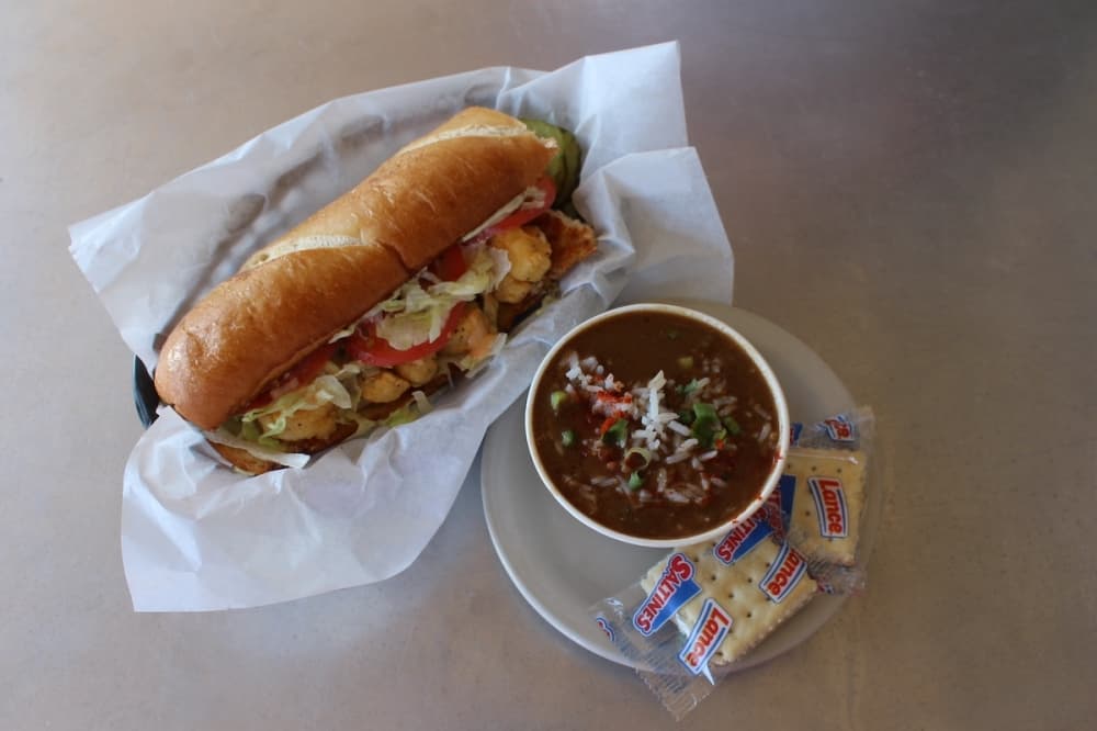 A fried shrimp Po-Boy with a cup of chicken and sausage gumbo. (Amira Van Leeuwen/Community Impact)