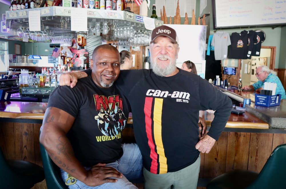 Two regular patrons of Hardtails Bar and Grill smile together