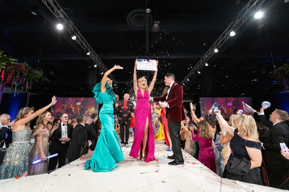Women wear gowns on a runway