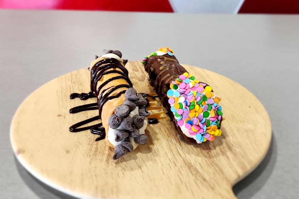 Cannolis coated in chocolate. 