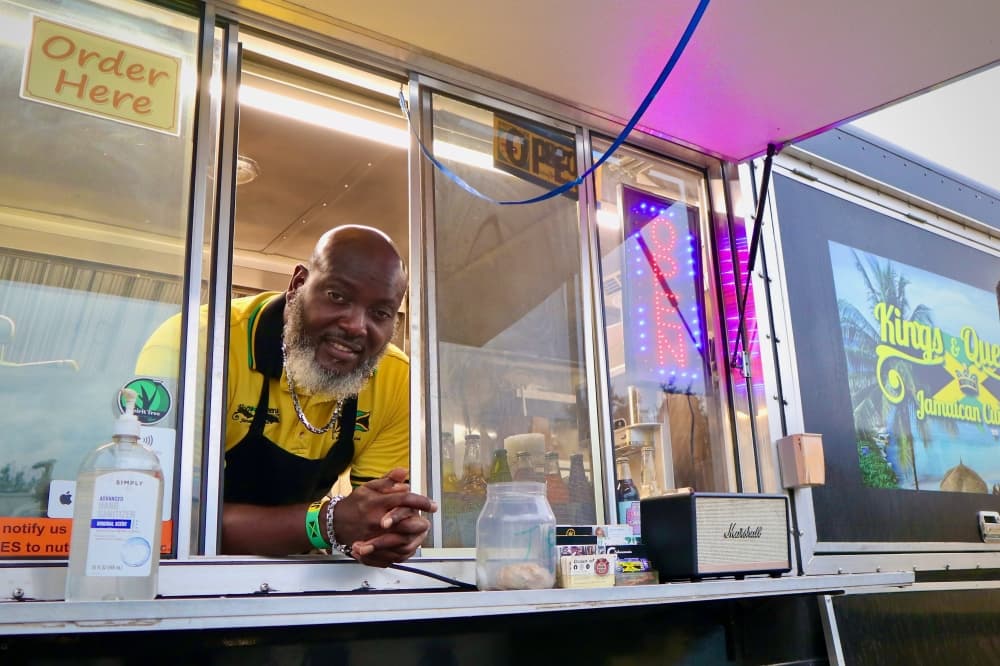 Owner Warren Dyer smiles at the window of his food truck