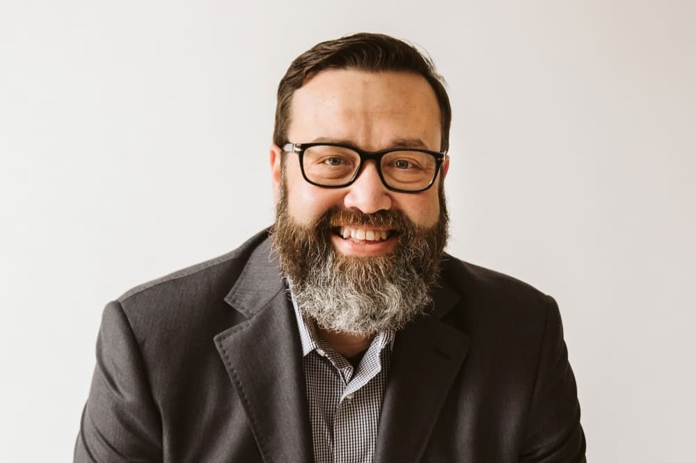 In this Q&A with Community Impact, DCX Community founder Chris Meroff discusses the evolution of the conference, highlighting its shift from internal professional development to a broader audience focus, with high-profile speakers and a strong emphasis on personal development.