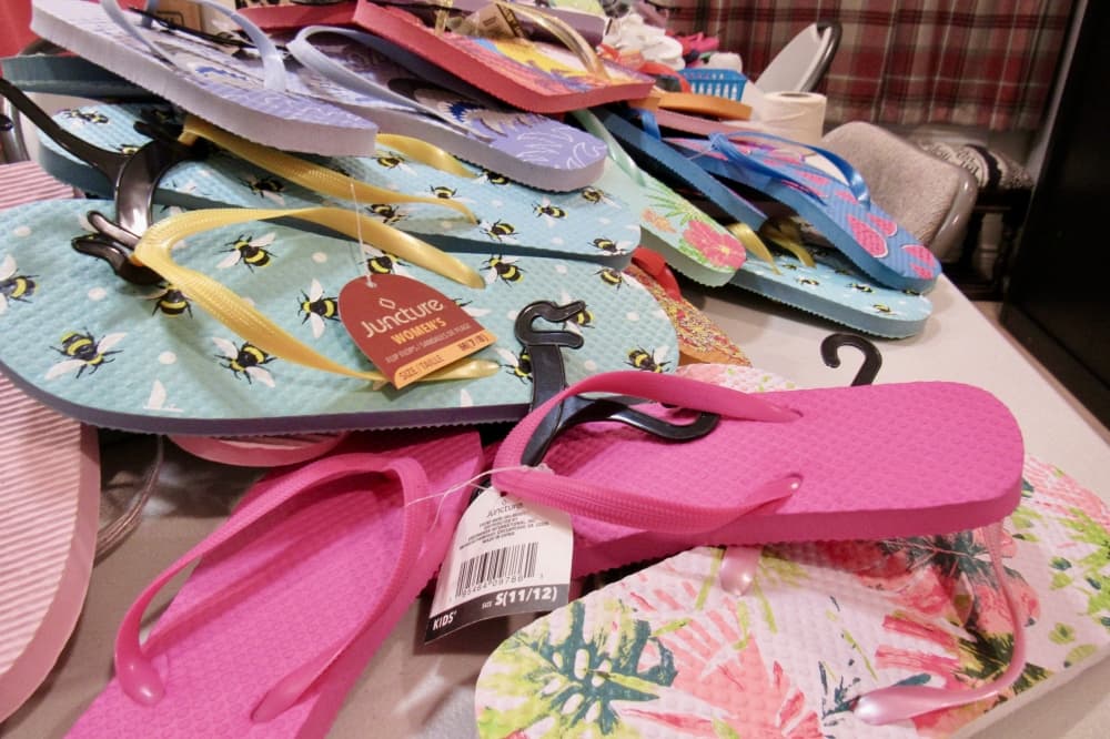 A variety of colorful flip-flops on a table.