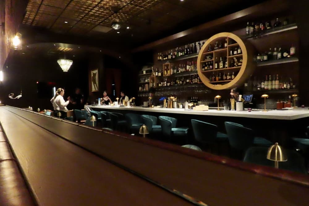 Employees gathered at the bar in The Wilfred, Plano's speakeasy. 