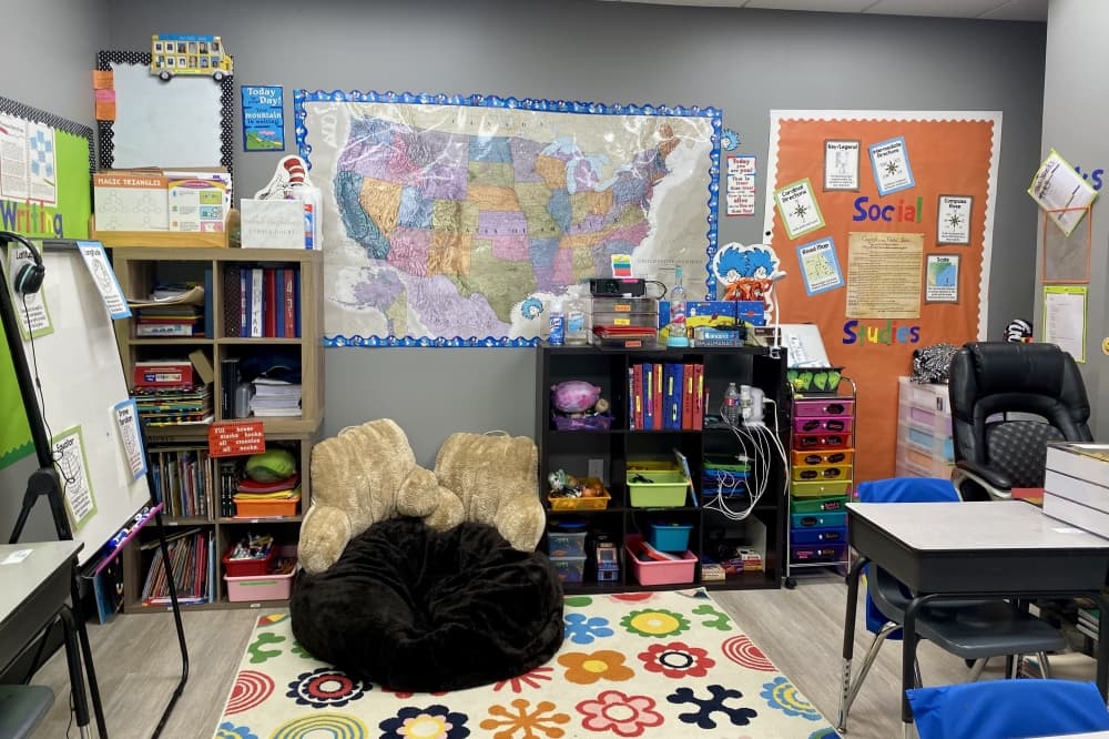 A classroom has cubby holes for items and a map on the wall.