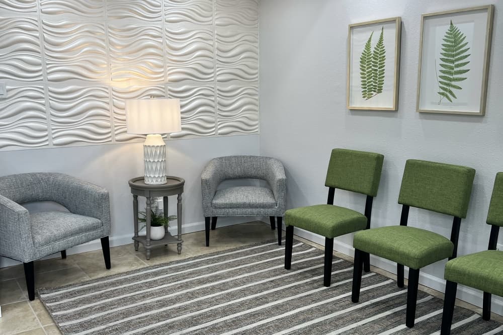 Waiting area with grey and green chairs