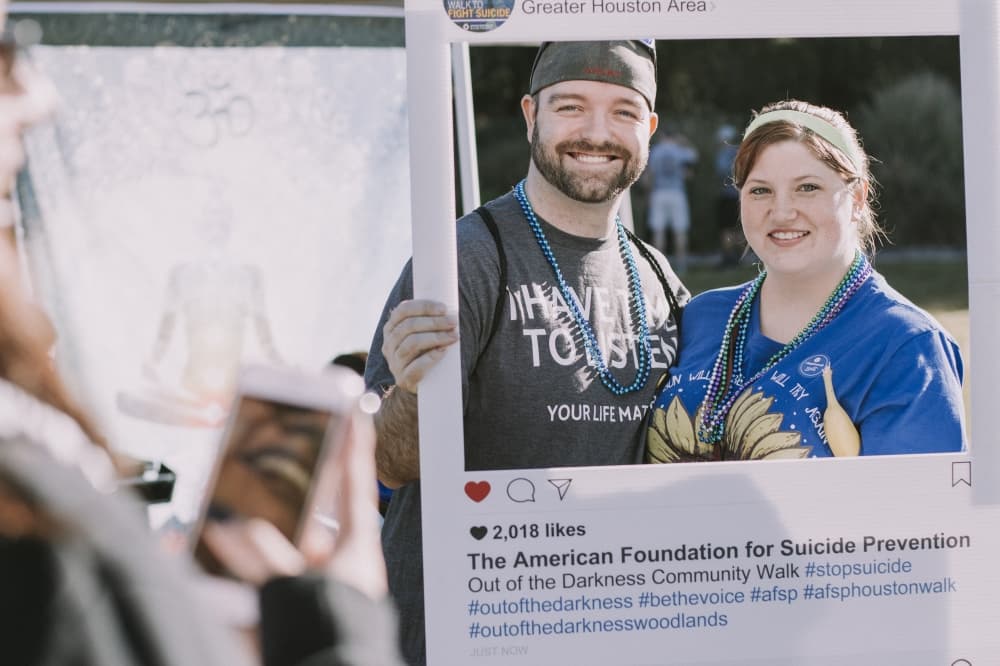 Men and Women taking photo with instagram tag  "American Foundation for Suicide Prevention" 
