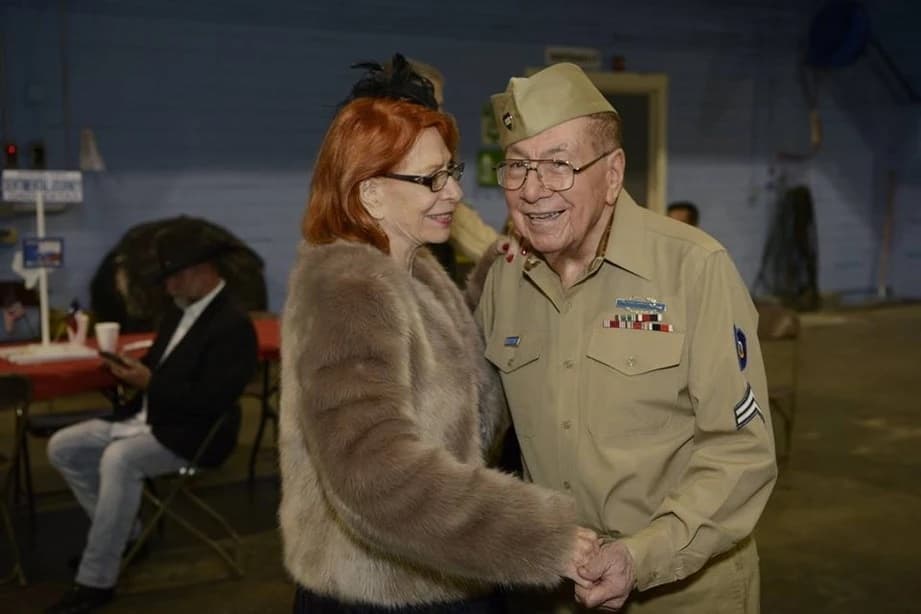 two people in military garb dance together