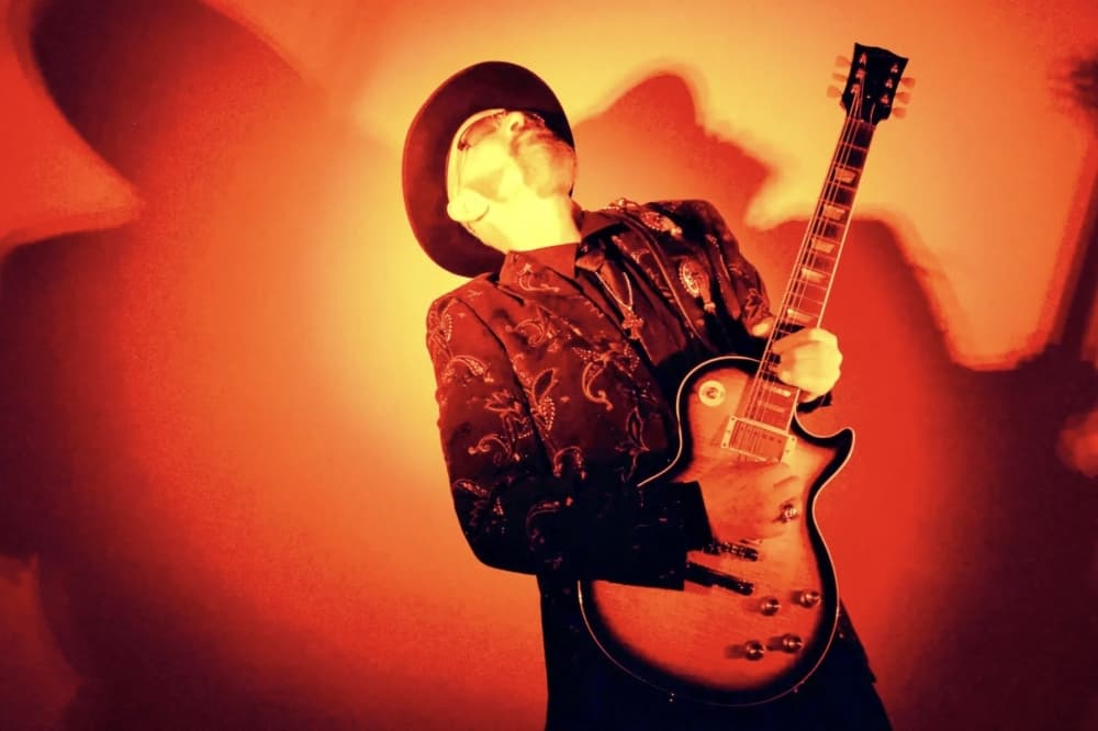 Mark May Band playing guitar, tilting head back