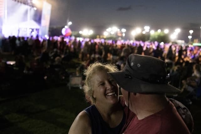 Picture of a couple dancing with a stage in the background