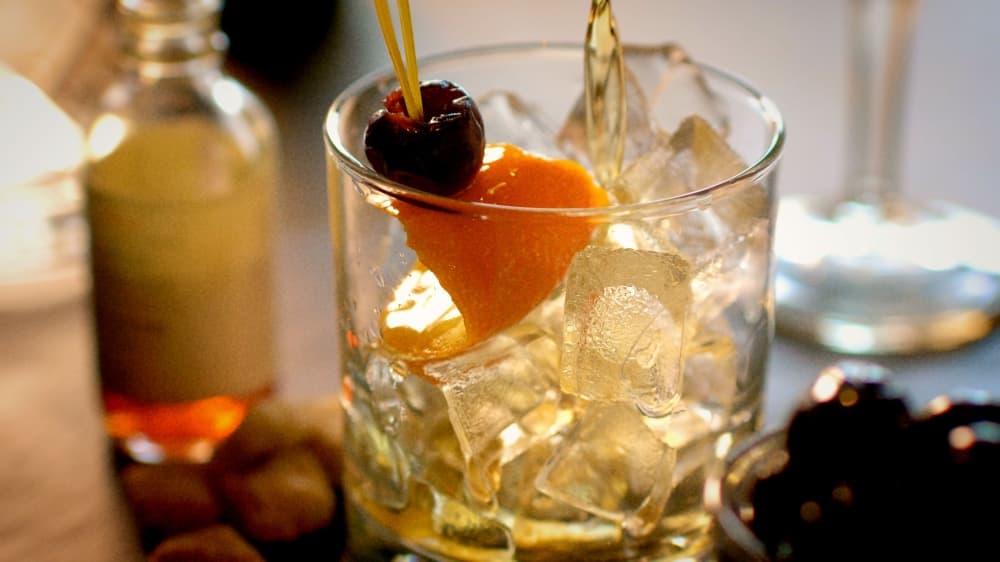 Cocktail glass with ice and fruit