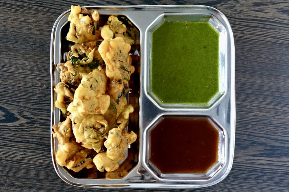 Mixed Veg Pakora dish with green and dark red sauce