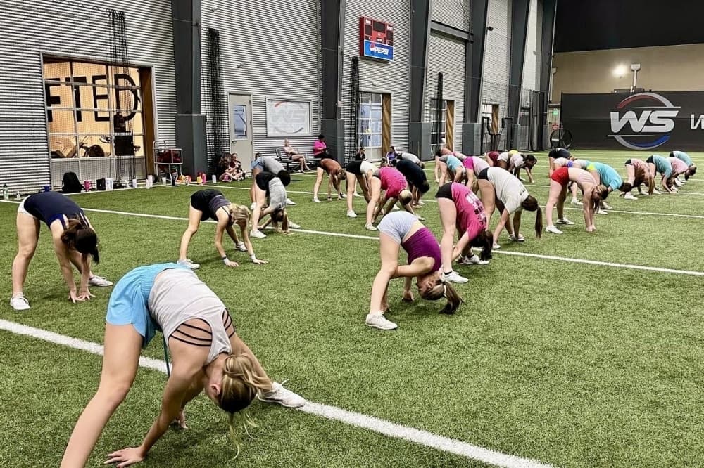 Tryout candidates warm-up for FIRST 15